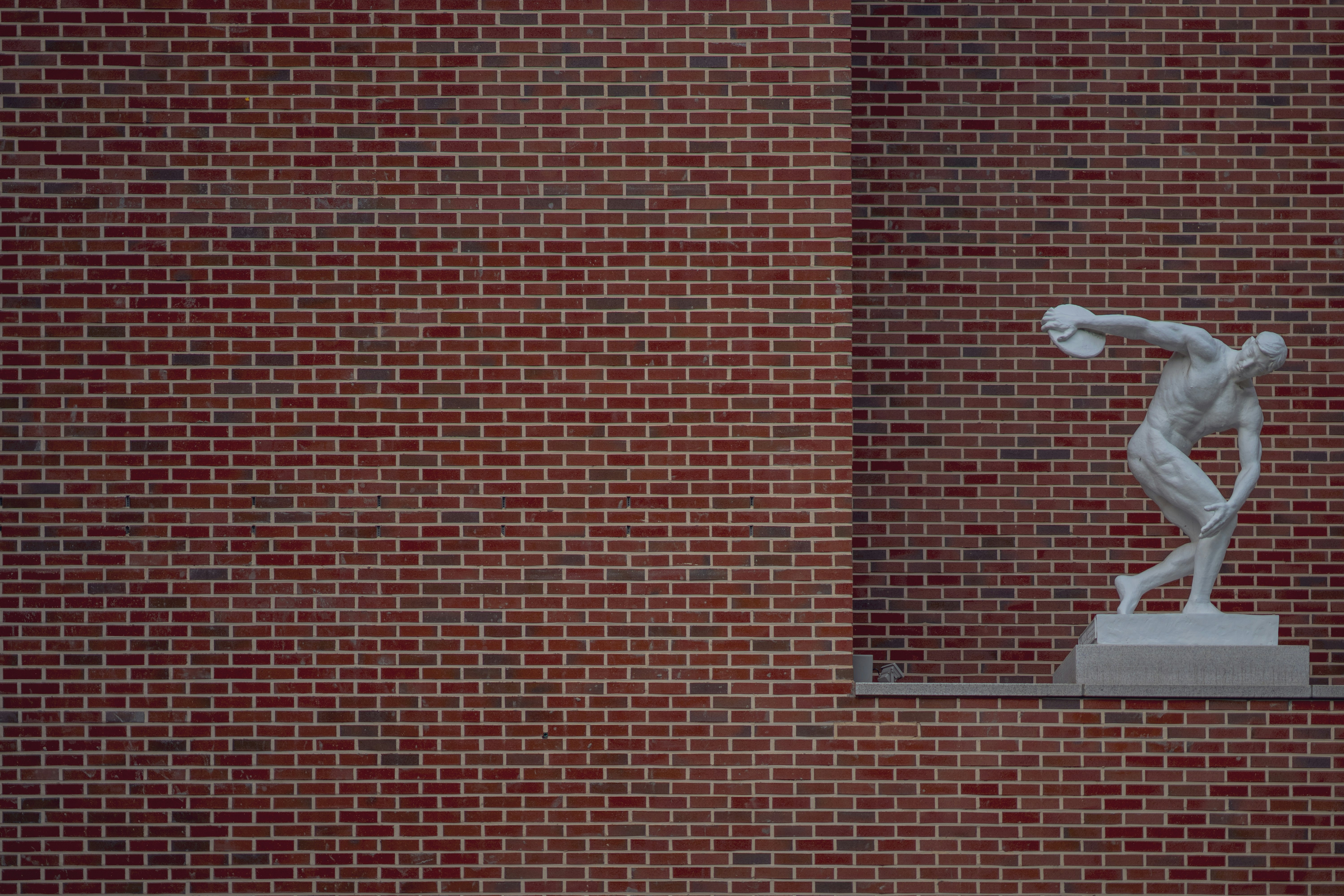 red brick wall with white heart sticker